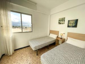 Postel nebo postele na pokoji v ubytování Apartamentos Gandia-Daimuz 3000