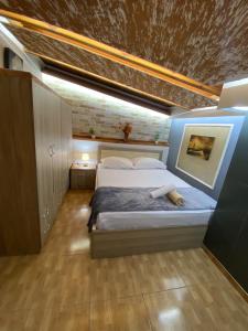 a bedroom with a large bed in a room at Vila Katalea in Gjirokastër