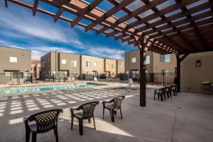 a patio with chairs and a swimming pool at Entrada at Moab 420 and 424 in Moab