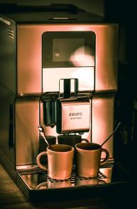 a coffee machine with two coffee cups on a shelf at "l'Escape room" - love room atypique in Saint-Martin-des-Entrées