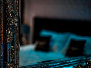 a close up of a mirror with a bed in the background at "l'Escape room" - love room atypique in Saint-Martin-des-Entrées