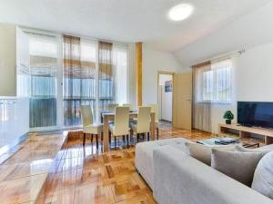 salon z kanapą, stołem i krzesłami w obiekcie Pool apartment Leonardo w mieście Gornji Karin