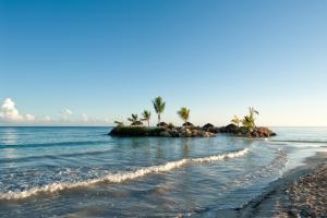 a small island in the ocean with palm trees at Hideaway at Royalton Blue Waters, An Autograph Collection all-Inclusive Resort - Adults Only in Falmouth