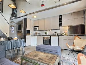 a kitchen with white cabinets and a table and chairs at Appartement Val-d'Isère, 4 pièces, 6 personnes - FR-1-411-682 in Val-d'Isère