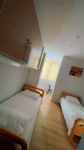 a room with two beds in a room at Tulip Apartment - Amazing Central Location in Tirana