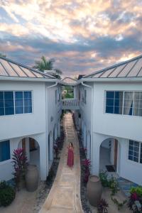 a woman standing in a hallway between two buildings at Blue Skies Beach Resort in Negril