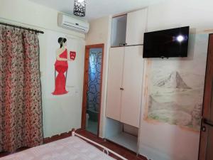 a room with a painting of a woman on the wall at Meteora Garden in Kalabaka