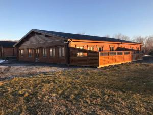 a large wooden house with a lot of windows at Gladheimar Guesthouse in Blönduós