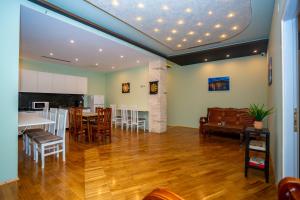 a kitchen and dining room with a table and chairs at Terrace Hostel & Lounge Bar in Shkodër