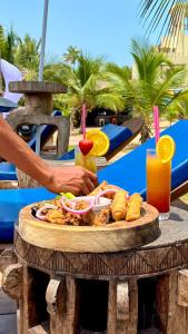 a plate of food on top of a table at The C Resort & Residences in Prampram