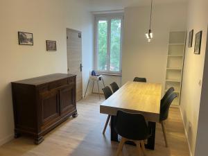 a dining room with a wooden table and chairs at Maison de vacances dans le Diois au pied du Vercors avec 2 chambres pour 6 personnes in Menglon
