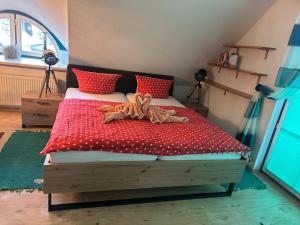 a bedroom with a bed with red pillows at Studio Übersee in Prerow