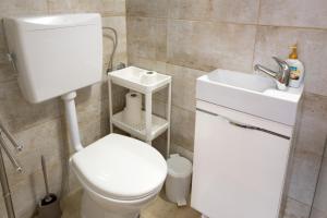 a bathroom with a toilet and a sink at Sant' Elena Room in Bale