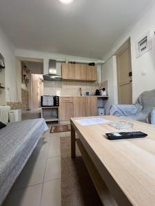 a kitchen with two beds and a table in a room at Nonas House in Kanoni