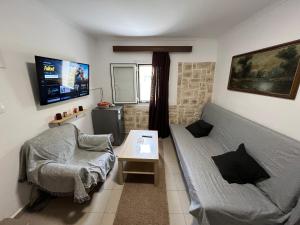 a living room with a couch and a table at Nonas House in Kanoni
