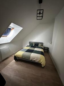 a bedroom with a bed in a room with a window at La nouvelle école in Ruillé-en-Champagne