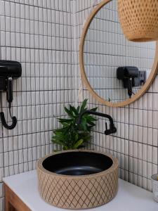 a bathroom with a sink with a plant in it at Gạo Homestay in Mui Ne