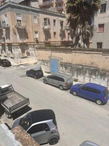 a group of cars parked on the side of a street at La casetta di Ludovica in Siracusa +6 photos