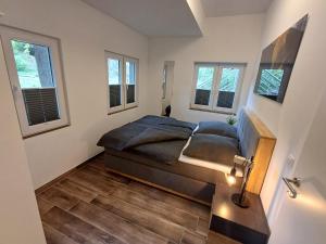 a bedroom with a bed in a room with windows at Ferienapartment Zur Bunten Kuh Walporzheim in Bad Neuenahr-Ahrweiler
