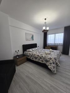 a bedroom with a bed and a couch in it at Edelweiss Retreat 1-Bedroom Apartment in Iskele +14 photos