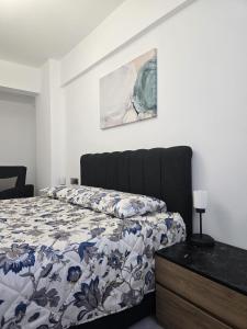 a bedroom with a bed with a blue and white comforter at Edelweiss Retreat 1-Bedroom Apartment in Iskele