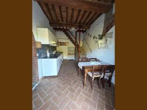 a kitchen and dining room with a table and chairs at La Casa Del Tiglio in Borgo San Lorenzo