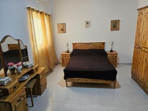 - une chambre avec un lit, 2 commodes et un bureau dans l'établissement House at Mosta view to Mdina, à Mosta
