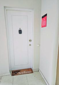 a white door in a room with a sign on it at Flat Triana in Las Palmas de Gran Canaria