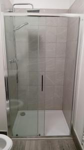 a shower with a glass door in a bathroom at Green Lodge-Room-04 in Liverpool