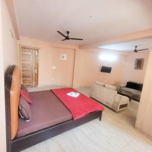 a bedroom with a bed and a living room at Hotel Vandana stay sec-08 in New Delhi