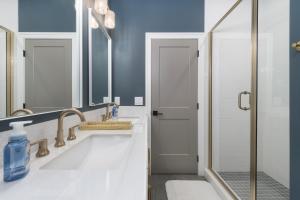 a bathroom with a sink and a shower at Sail Away South Beach- pool-bike trails-close to beach in South Haven +29 photos