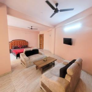 a living room with a couch and a table at Hotel Vandana stay sec-08 in New Delhi