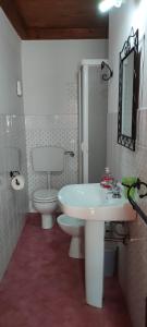 a bathroom with a white sink and a toilet at Mandra Chiusilla in Collesano +43 photos