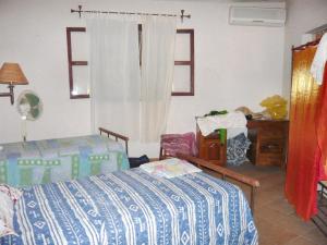 a bedroom with a bed and a dresser and a window at 3 bedrooms house at Cap Skirring 800 m away from the beach with lake view private pool and enclosed garden in Cap Skirring