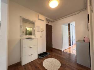 a room with a white dresser and a mirror at Apartment EF in Sarajevo
