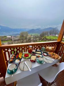 a table with plates of food on a balcony at Berkri Gastro Yard & Guest House in Yenokavan