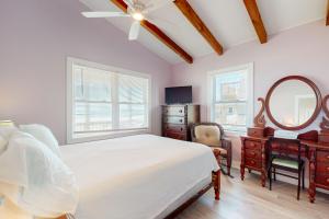 a bedroom with a bed and a mirror and a dresser at HB21 Austin Cottage in Holden Beach