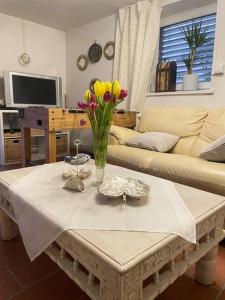 a living room with a table with flowers on it at Apartment with garden in Krems an der Donau