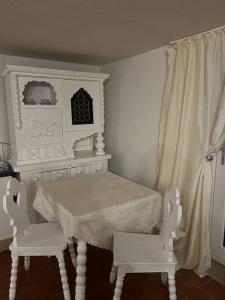 a white room with a table and two white chairs at Apartment with garden in Krems an der Donau