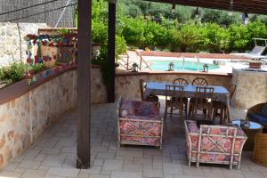 a patio with a table and chairs and a pool at trulli Annina in Locorotondo