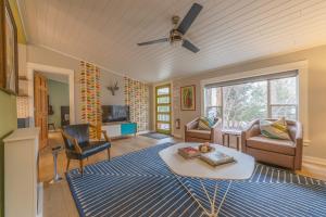 a living room with a ceiling fan and a table at Douglas Woods Retreat - Modern Cottage - Newly Remodeled! Walking distance to downtown Douglas! in Douglas