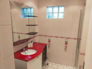 a bathroom with a red sink and a mirror at Longère 10 personnes in Vauchelles-lès-Quesnoy