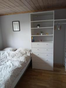 a bedroom with a bed and a dresser at La Casa Marrone Norway in Asker