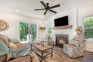 a living room with a couch and a fireplace at Happy Landings - Farmhouse coastal home with tram and stairs to beach access! in South Haven