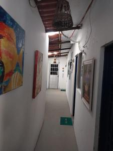 a hallway with paintings on the walls of a building at Pousada Porto Marola in Porto De Galinhas