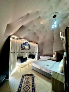 um quarto com uma cama grande num sótão em RUM CHEERFUL lUXURY CAMP em Wadi Rum
