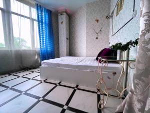 a bedroom with a bed and a table on a tiled floor at ПЛЯЖ Otrada Две Спальни на Французском бульваре, centre, Delux Большой апартамент in Odesa +33 photos