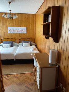 a bedroom with a bed and a desk in it at Piso O Percebe in Muxia