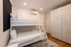 a small room with two bunk beds in it at Entire House in Port Melbourne w Parking & Pool in Melbourne