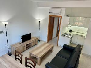a living room with a couch and a table at Alba Radiosa in Santa Caterina Dello Ionio Marina